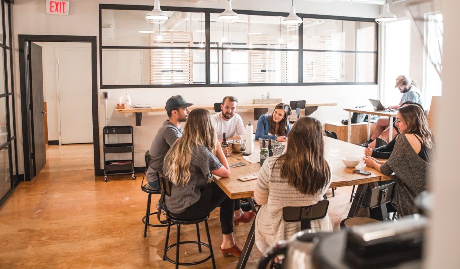 talking people sitting beside table