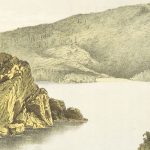 grayscale photo of mountain near body of water