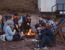 group of people sitting on front firepit