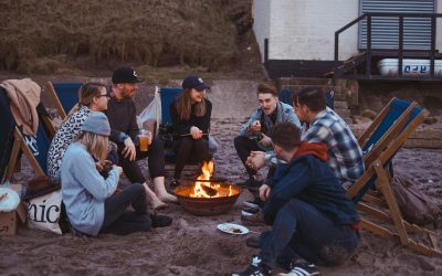 group of people sitting on front firepit