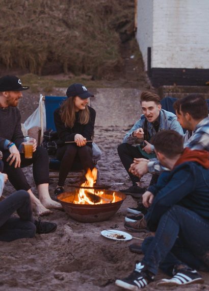 group of people sitting on front firepit