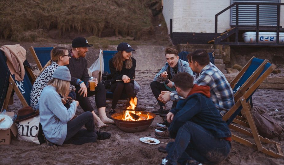 group of people sitting on front firepit