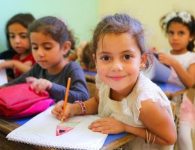 A group of young children sitting at a desk