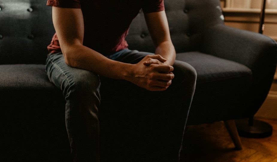 man sitting on sofa